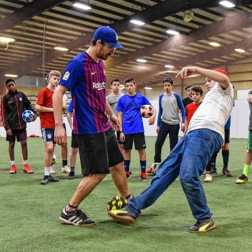 Nick Rogers, left, of California helps Kristoffer Liicht of Denmark, co-founder of Copenhagen Panna House, demonstrate a technique during a three-day soccer skills workshop at Allsport Soccer Arena in Northampton on Monday, Feb. 18, 2019.